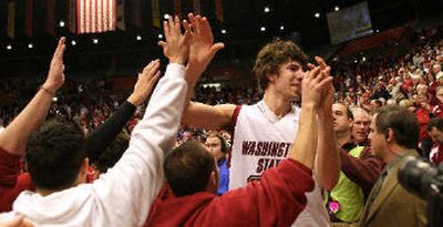 
Robbie Cowgill leaves the court surrounded by students who stormed the floor. 
 (Amanda Smith Special to / The Spokesman-Review)