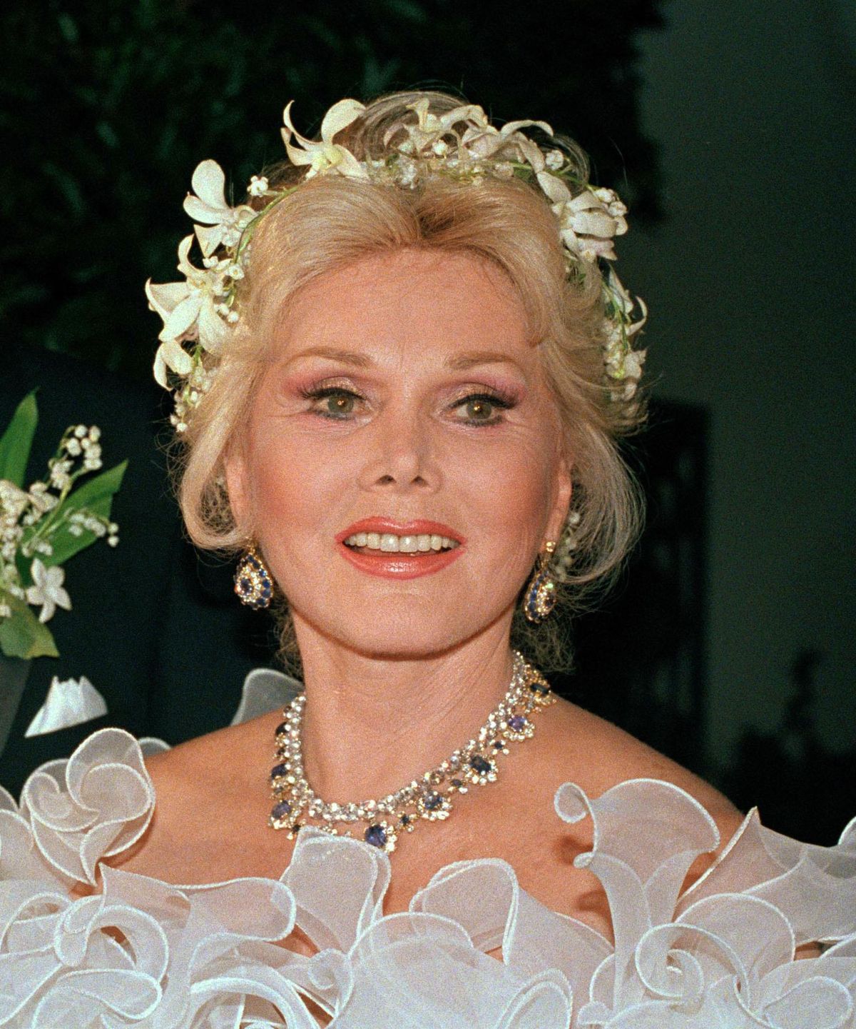 In this Aug. 15, 1986  photo, actress Zsa Zsa Gabor smiles in Los Angeles. Gabor was remembered at a funeral Mass Friday, Dec. 30, 2016, at a picturesque Beverly Hills church not only for her fame, but also what a pastor called her lesser-known compassionate side. The Hungarian-American actress died Dec. 18, 2016, from a heart attack at age 99. (Associated Press)