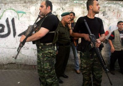 
Palestinian security force officers loyal to the Fatah movement keep guard in a Gaza City street Saturday after a cease-fire agreement with rival Hamas forces was signed. 
 (Associated Press / The Spokesman-Review)