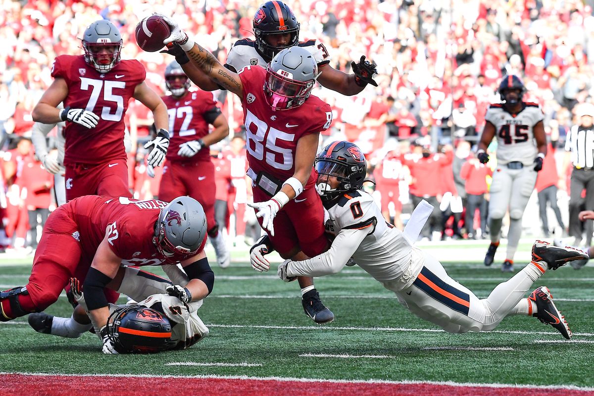 Washington State Cougars wide receiver Lincoln Victor (85) dives into the endzone for a touchdown against Oregon State Beavers defensive back Akili Arnold (0) during the second half of college football game on Saturday,Oct 9, 2021, at Martin Stadium in Pullman, Wash. WSU won the game 31-24.  (Tyler Tjomsland/The Spokesman-Review)