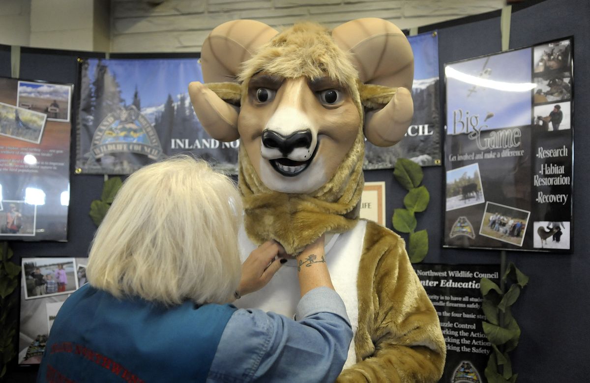 Wanda Clifford helps Chuck Hubbard dress as “Bighorn Bill,” the mascot of the Wildlife Council who spent Tuesday wandering the fairgrounds. (Christopher Anderson / The Spokesman-Review)