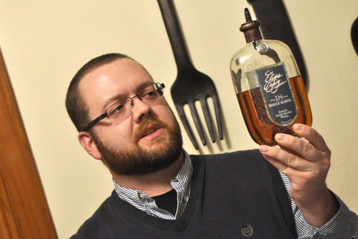 Jim Briggs, 33, founder of Spokane Whiskey Club, discusses the finer points of an Elijah Craig 18-year-old single-barrel bourbon. Bourbon is his favorite kind of whiskey.