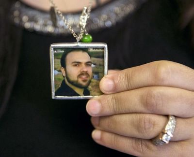 In this June 2, 2015 file photo, Naghmeh Abedini holds a necklace with a photograph of her husband, pastor Saeed Abedini, on Capitol Hill in Washington. (Jacquelyn Martin / Associated Press)