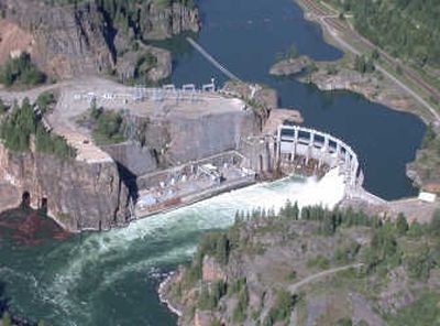 
Water spills over Avista Utilities' Cabinet Gorge Dam in northwest Montana. The state wants utilities to pay rent for the land on which dams sit. The case has gone to trial, but a settlement is possible.
 (File / The Spokesman-Review)