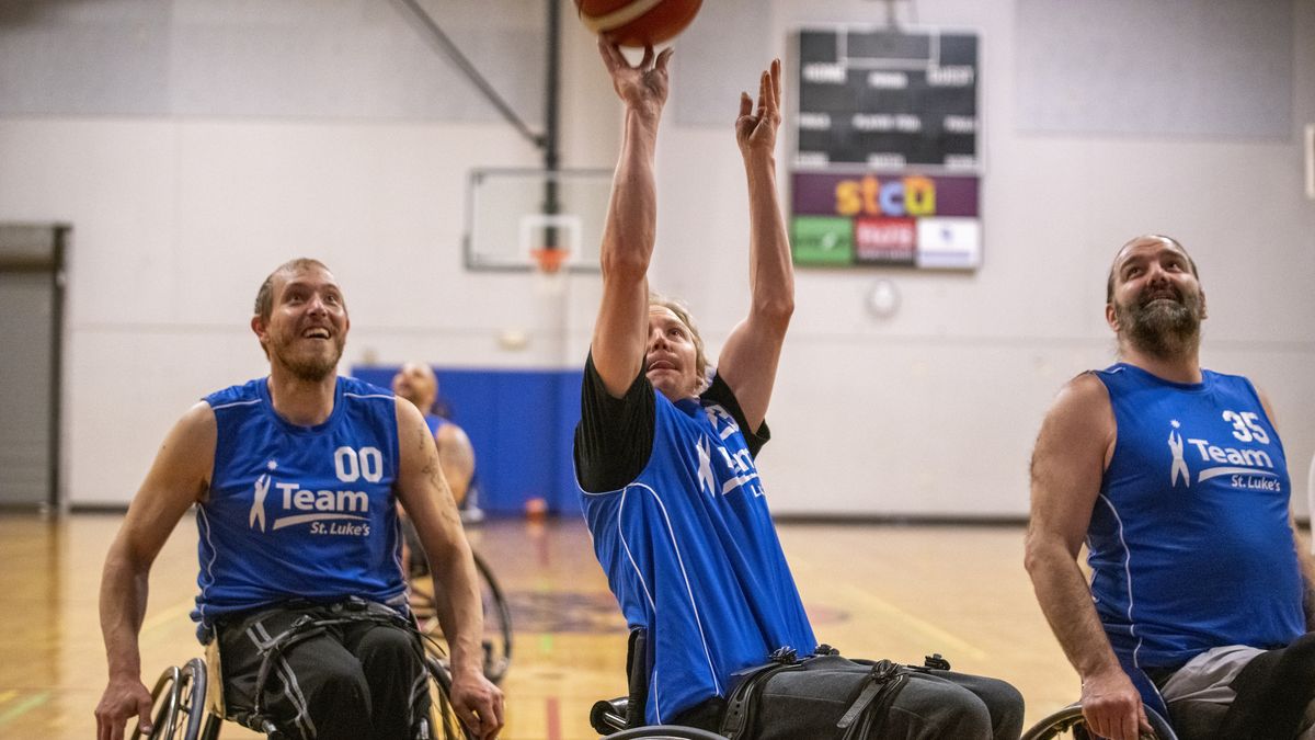 Kevin Goodan, center, shoots in the paint, surrounded by Cody Mace, left, and James Herndon during practice with Team St. Luke’s Friday at the HUB Sports Center in Liberty Lake. (Jesse Tinsley/The Spokesman-Review)