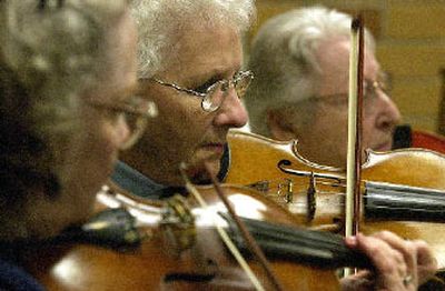 
Second violins  of the Coeur d'Alene Symphony work their way through a rehearsal. 
 (File/ / The Spokesman-Review)