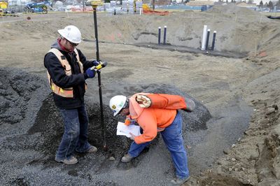 Surveyors Taryn Van Houten, left, and Richie Payne plot out the shape of the new Shadle pool last Thursday.  (Jesse Tinsley / The Spokesman-Review)