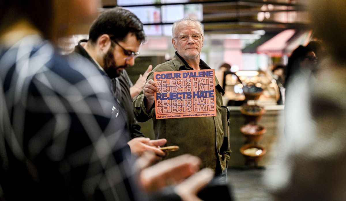 Tom Sanner holds a “Coeur d’Alene Rejects Hate” sign toward David Reilly, left, a self-proclaimed Christian nationalist, during a news conference about the racial harassment of a group of basketball players from the University of Utah women’s team during the NCAA tournament in Spokane in March 2024.  (Kathy Plonka/The Spokesman-Review)