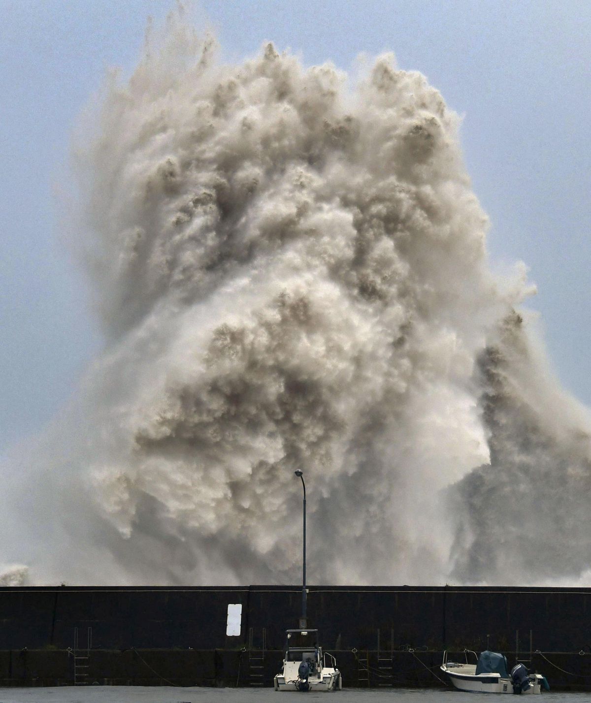 High waves hit a fishing port in Aki, Kochi prefecture, western Japan, on Thursday, Aug. 23, 2018. A typhoon is expected to cross western Japan on Thursday night. Japan’s weather agency has warned of strong gusts, high waves and heavy rain. (Chika Oshima / AP)