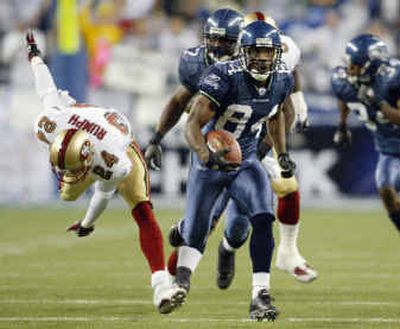 
Bobby Engram breaks free from diving 49er Mike Rumph to return a kickoff for a touchdown in 2002. 
 (File/Associated Press / The Spokesman-Review)