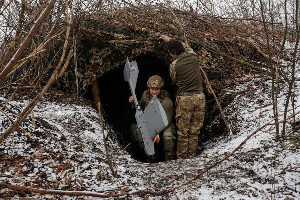 Servicemen of Ukraine’s 66th Separate Mechanized Brigade leave their dugout Tuesday with a Darts middle-range strike unmanned aerial vehicle before launching it toward Russian troops from their position near a frontline, amid Russia’s attack on Ukraine in the Donetsk region of Ukraine. (Sofiia Gatilova)