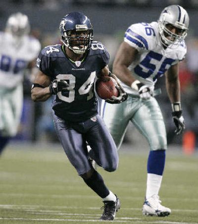 
Seattle's Bobby Engram runs after catching a pass in Saturday's wild-card playoff win.
 (Associated Press / The Spokesman-Review)