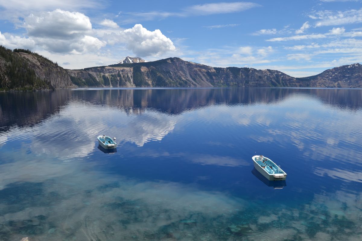 Boats float in the water at the dock area at Crater Lake National Park from the Cleetwood Cove Trail. (Associated Press)