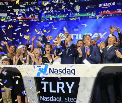 Brendan Kennedy, third from right in front, CEO and founder of British Columbia-based Tilray Inc., a major Canadian marijuana grower, leads cheers as confetti falls to celebrate his company's IPO (TLRY) at Nasdaq, Thursday, July 19, 2018, in New York. (Bebeto Matthews / Associated Press)