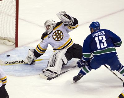 Vancouver Canucks left wing Raffi Torres scores the winning goal against Boston Bruins goalie Tim Thomas during the third period. (Associated Press)