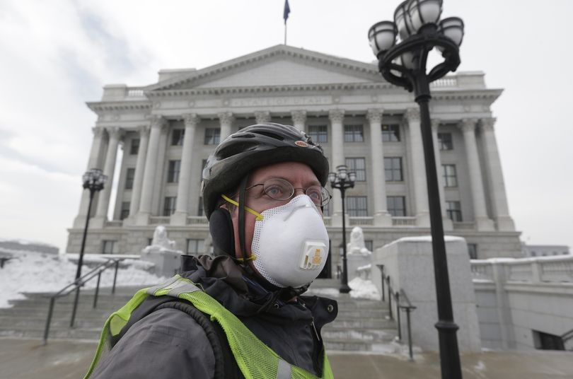 Dr. Gary Kunkel arrives at the Utah State Capitol wearing a breathing mask Wednesday. (Associated Press)