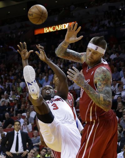 Detroit’s Rodney Stuckey, left, commits an offensive foul. (Associated Press)