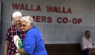 
Jackie Piatt, in blue, and Greta Joy Palmer hug before Piatt boards a Greyhound bus in Walla Walla, which will lose service Aug. 18. Piatt has used Greyhound for years to visit friends.
 (Jed Conklin photos/ / The Spokesman-Review)