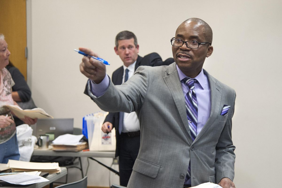 Public defender Francis Adewale, center front, and prosecutor Adam Papini, rear, talk to Community Court participants, Feb. 29, 2016, at the the Spokane Public Library in downtown Spokane. (Dan Pelle / The Spokesman-Review)
