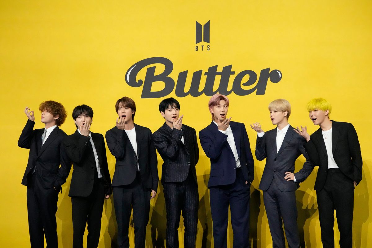 Members of South Korean K-pop band BTS, V, SUGA, JIN, Jung Kook, RM, Jimin, and j-hope from left to right, pose for photographers ahead of a press conference to introduce their new single "Butter" in Seoul, South Korea, Friday, May 21, 2021. Three members of the K-pop superstar group BTS have been infected with the coronavirus.  the Big Hit Entertainment agency says in a statement that RM and Jin were diagnosed with COVID-19 on Saturday evening. It earlier said another member, Suga, tested positive for the virus on Friday.  (Lee Jin-man)