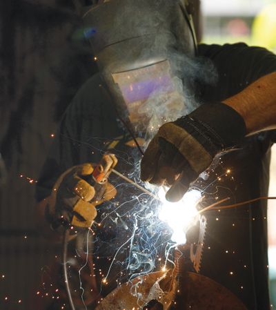 Artist Jim Lockwood works at his shop earlier this month in Roseburg, Ore. The Roseburg native has been welding metal sculptures for eight years. (Associated Press)