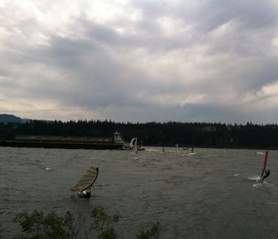Windsurfers and kitesailers, a major sailboat race, and a barge all converge on the Columbia River near Hood River, Ore. (Betsy Russell)