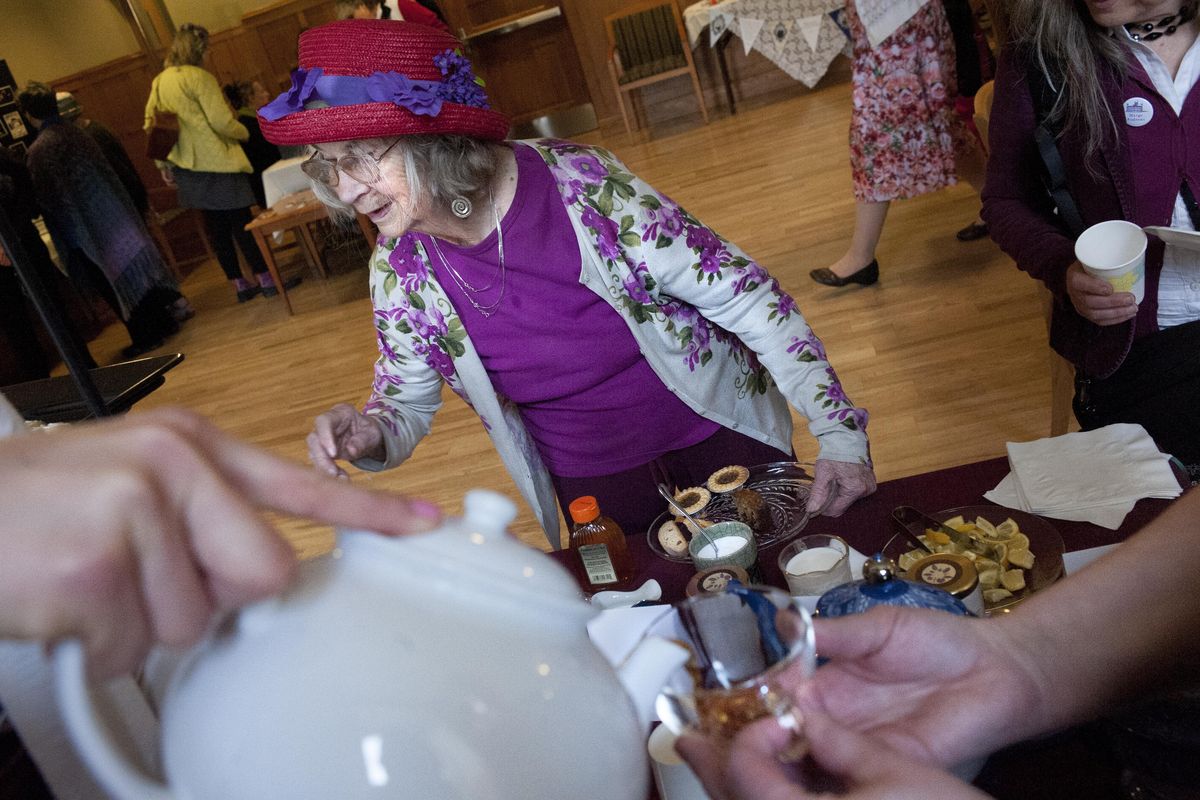Marion Moos a donor attending the 16th Annual "Downton Abbey" themed H.O.M.E. Childcare Scholarship Fundraiser Tea smiles as she is served on Wednesday, April 23, 2014, at EWU in Cheney, Wash. The event was presented by the Women