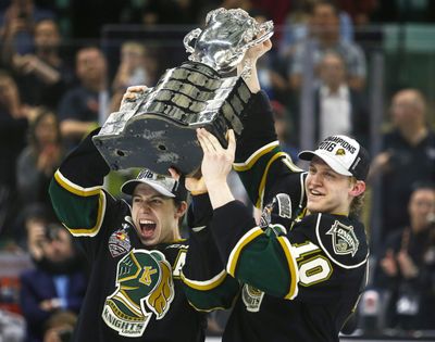 London Knights Mitchell Marner, left, and Christian Dvorak lift the Memorial Cup as they celebrate their overtime victory in the Memorial Cup championship game over the Rouyn-Noranda Huskies in Red Deer, Alberta. (Jeff McIntosh / Canadian Press)
