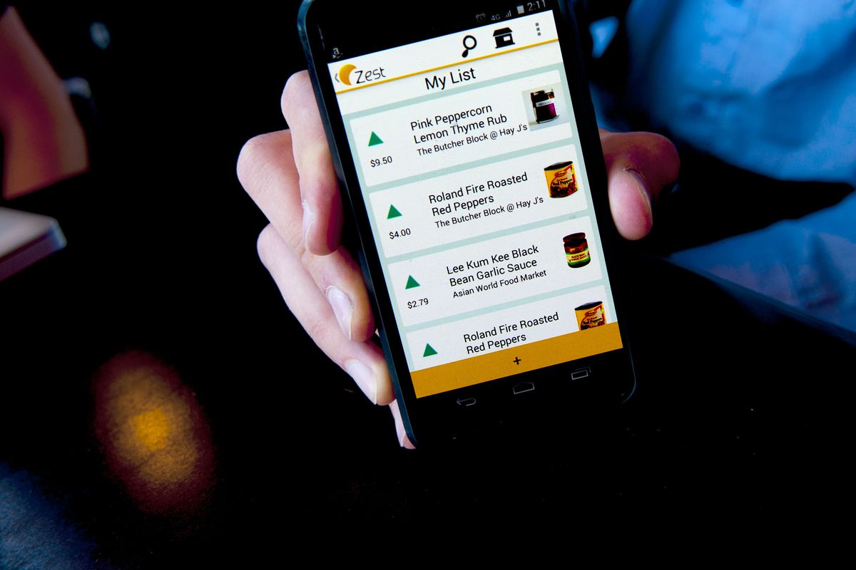 Fletcher Wilkens shows the shopping list for the new mobile app, Zest that he and Dustin Horn developed to help small grocery businesses reach more customers.