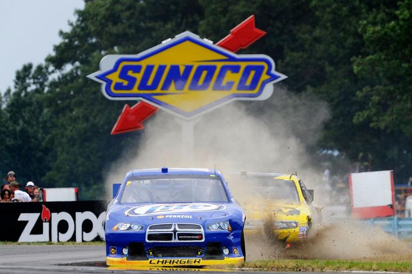 Brad Keselowski leads Marcos Ambrose as both cars skid through the grass in the backstretch chicane on the final lap of the NASCAR Sprint Cup Series' Finger Lakes 355 at Watkins Glen (N.Y.) International. (Photo Credit: By John Harrelson, Getty Images for NASCAR) (John Harrelson / Getty Images North America)