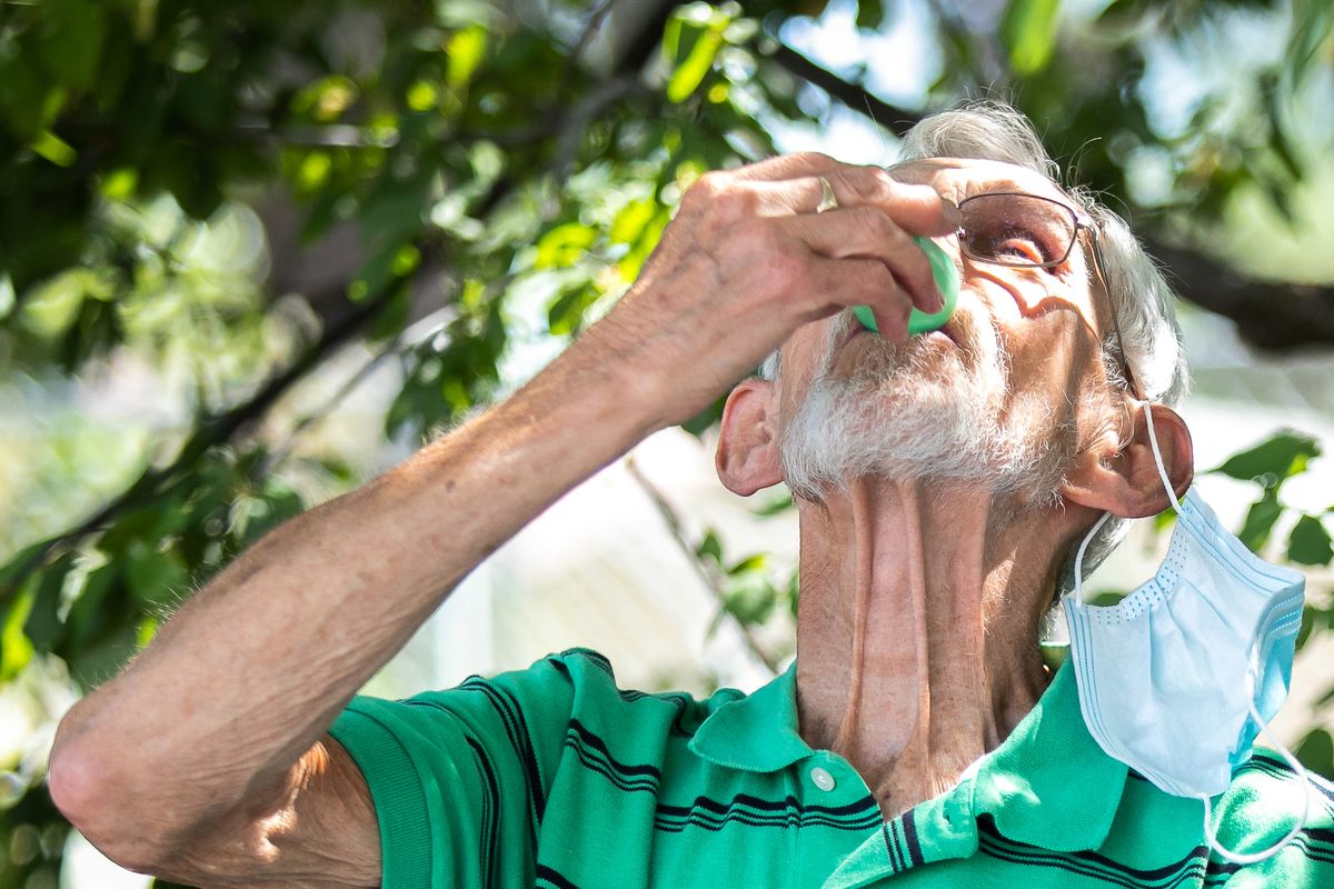 Dick Haunschild, a 30-year member of Shadle Park Presbyterian Church, takes communion in the parking lot of the church in Spokane on Sunday during the COVID-19 pandemic.  (Libby Kamrowski/ THE SPOKESMAN-REVIEW)