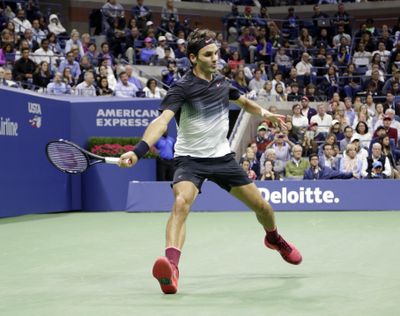 Roger Federer reaches for a shot from Feliciano Lopez during the U.S. Open on Saturday. (Seth Wenig / Associated Press)