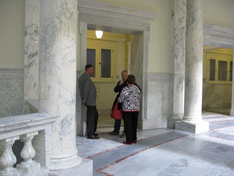 Idaho redistricting commissioners Randy Hansen, left, Ron Beitelspacher and Dolores Crow visit on the fourth floor of the state Capitol Wednesday about their meeting schedule, before deciding to take Thursday off to allow a software glitch to be fixed before they convene again on Friday. (Betsy Russell)