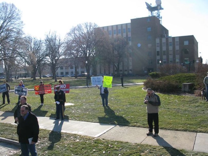 A handful of protesters stood at the back of the crowd for Friday's inaugural ceremony in Boise (Betsy Russell)