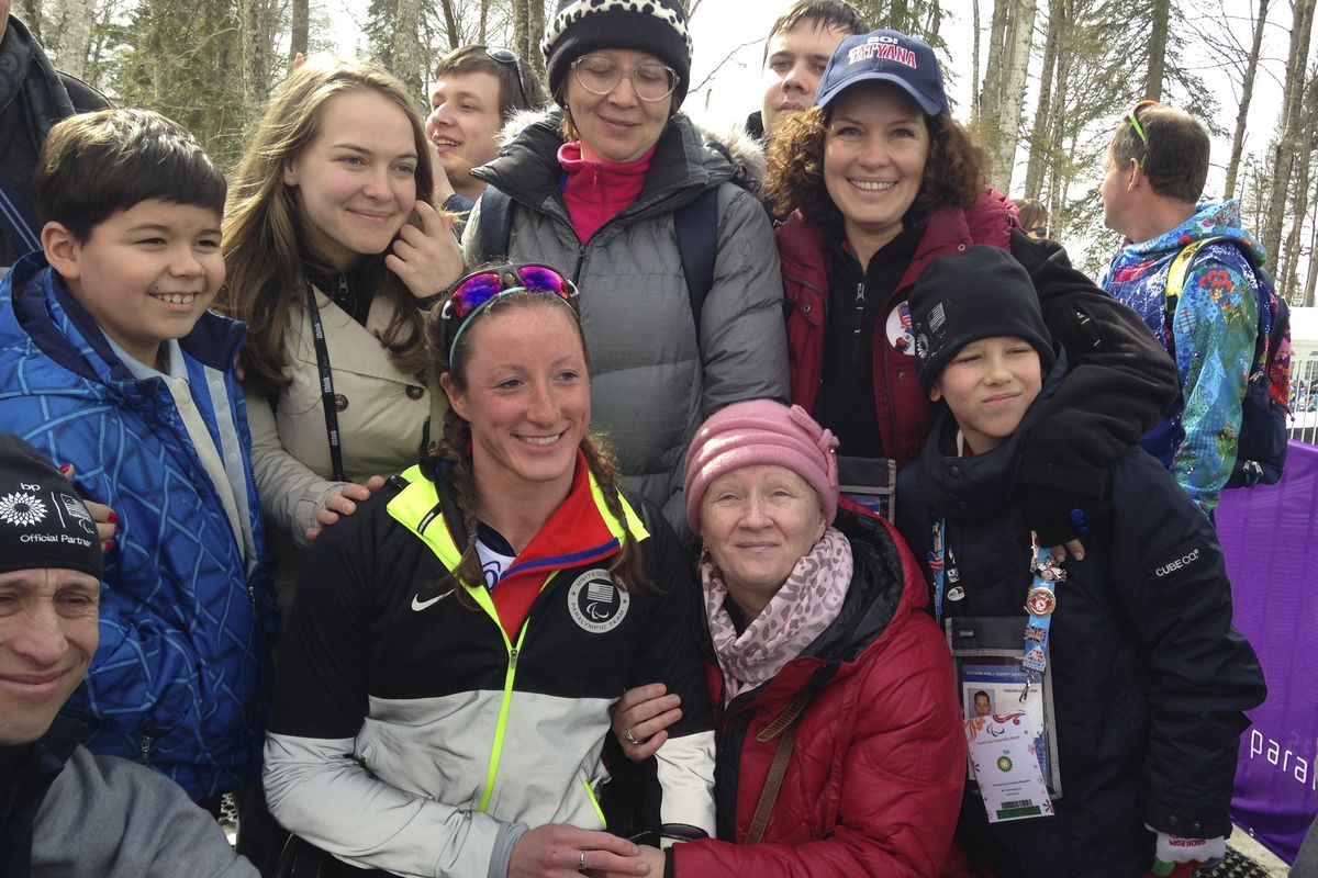 Tatyana McFadden, second left in first row, poses with her Russian birth mom after being estranged for more than 20 years. (Associated Press)