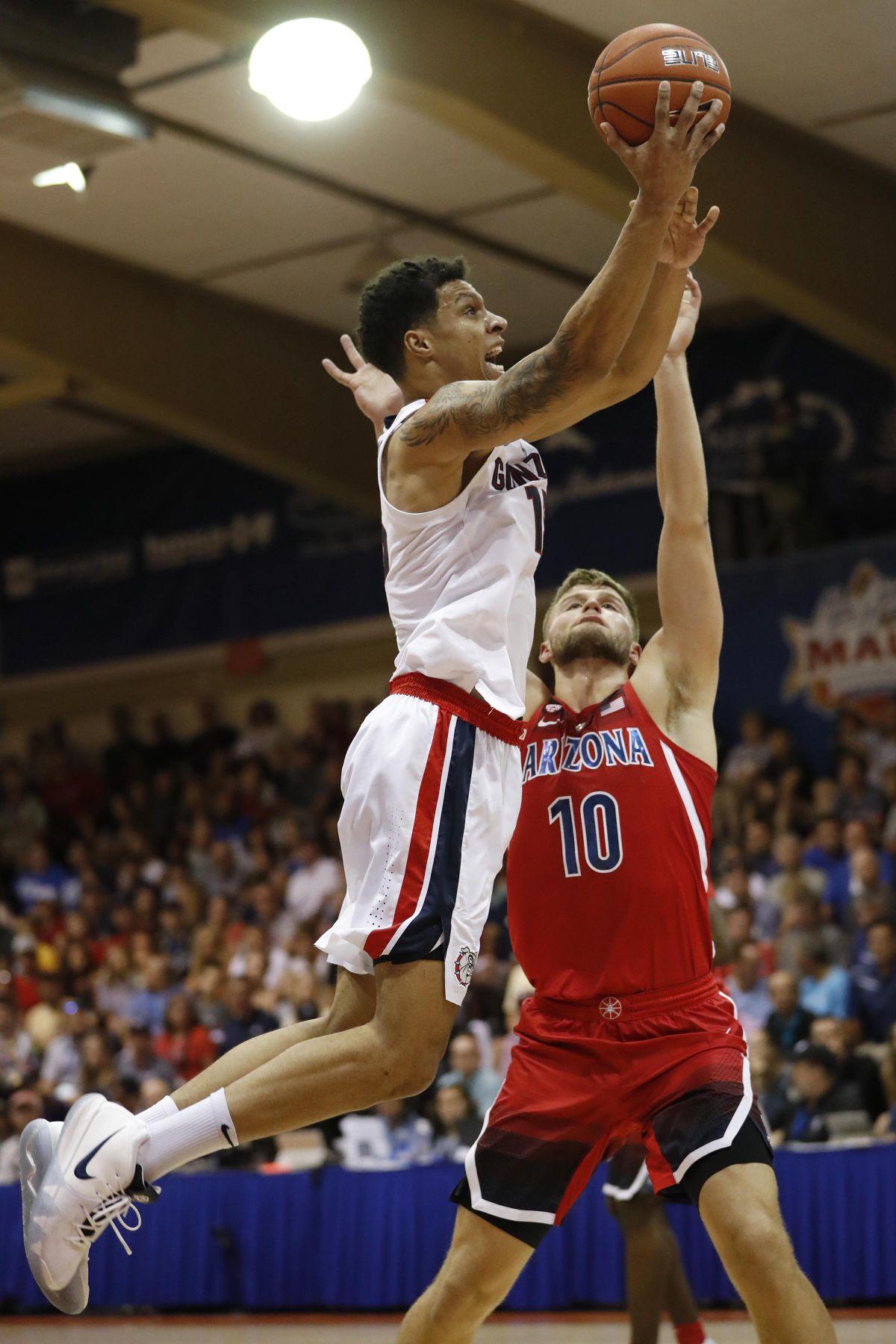 Gonzaga forward Brandon Clarke (15) leaps over Arizona forward Ryan Luther (10) during the first half of an NCAA college basketball game at the Maui Invitational, Tuesday, Nov. 20, 2018, in Lahaina, Hawaii. (Marco Garcia / Associated Press)