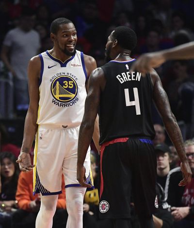 Golden State Warriors forward Kevin Durant, left, and Los Angeles Clippers forward JaMychal Green jaw at each other during the second half in Game 3 of a first-round NBA basketball playoff series Thursday, April 18, 2019, in Los Angeles. The Warriors won 132-105. (Mark J. Terrill / Associated Press)
