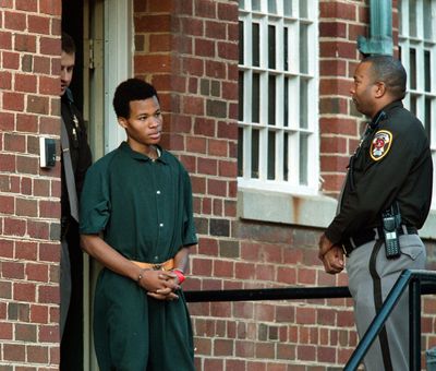 Lee Boyd Malvo, then 17, emerges from a hearing at Fairfax County, Va., Juvenile and Domestic Relations District Court in 2002.  (Rich Lipski/The Washington Post)