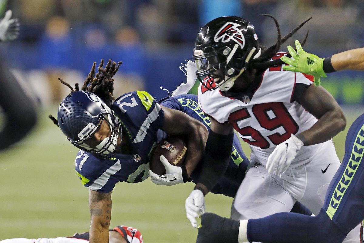 Seattle Seahawks’ J.D. McKissic (21) tumbles between Atlanta Falcons De’Vondre Campbell (59) and Damontae Kazee on a carry in the first half of an NFL football game, Monday, Nov. 20, 2017, in Seattle. (Stephen Brashear / Associated Press)
