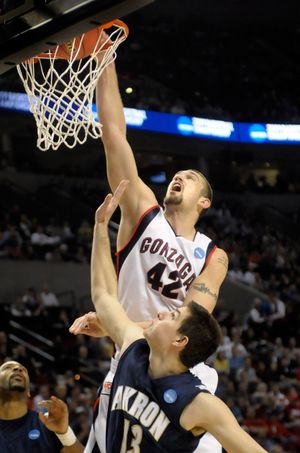 Josh Heytvelt of Gonzaga gets a putback slam during first half action against Akron in the opening round of the NCAA Tournament in the Portland Oregon Rose Garden Thursday, March 19, 2009.   At bottom is #13 Nikola  Cvetinovic of Akron.  (Christopher Anderson / The Spokesman-Review)