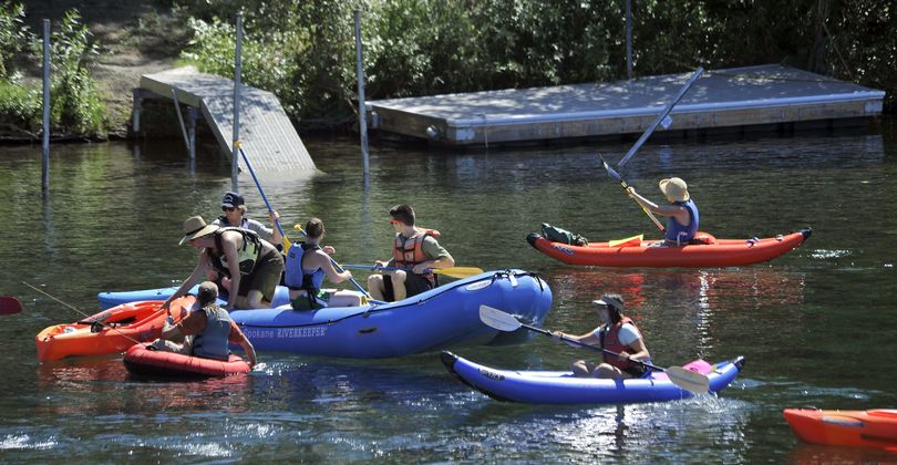 On Sunday, rafters, kayakers and canoeists protest the proposal to build docks along the Spokane River. (Dan Pelle)