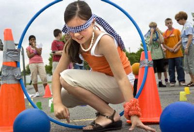 
Bemiss Elementary School fourth-grader Samantha Olson navigates an obstacle course while wearing a blindfold during the school's field day Monday. 
 (Photos by Holly Pickett / The Spokesman-Review)