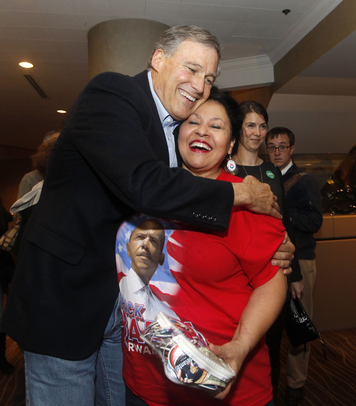 Democrat Jay Inslee hugs supporter Antonia Gonzalez Tuesday in Seattle. (Associated Press)