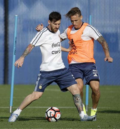 Argentina’s Lionel Messi, left, protects the ball from Lucas Biglia during a training session ahead of the team’s Copa America soccer final against Chile. (Julio Cortez / Associated Press)