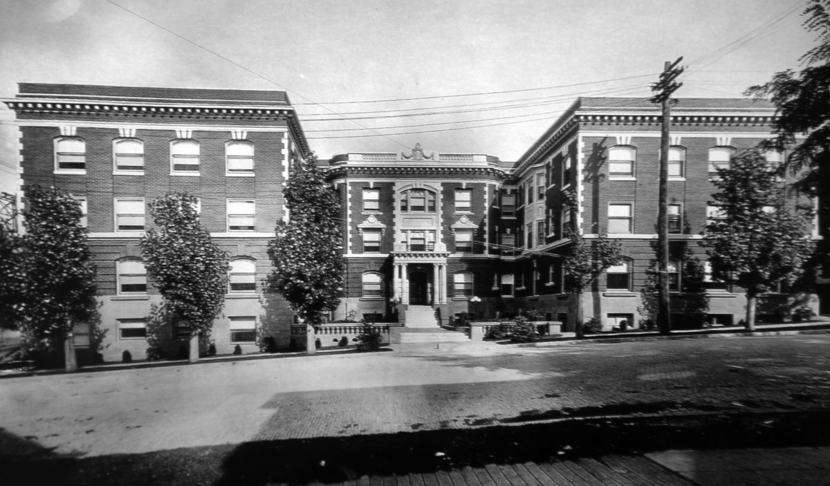 1922: The Knickerbocker Apartments, built by businessman Graham B. Dennis in 1911 on land he bought in 1887, was one of the most luxurious multifamily residences in the city of Spokane, which Dennis intended to occupy himself. Architect Albert Held designed the three-story luxury apartment building faced in red brick and ornamented with off-white glazed terra cotta. Dennis had told the architect he wanted “the finest apartment house west of New York.” The building cost $200,000.  (Photo courtesy of Mary Braden)