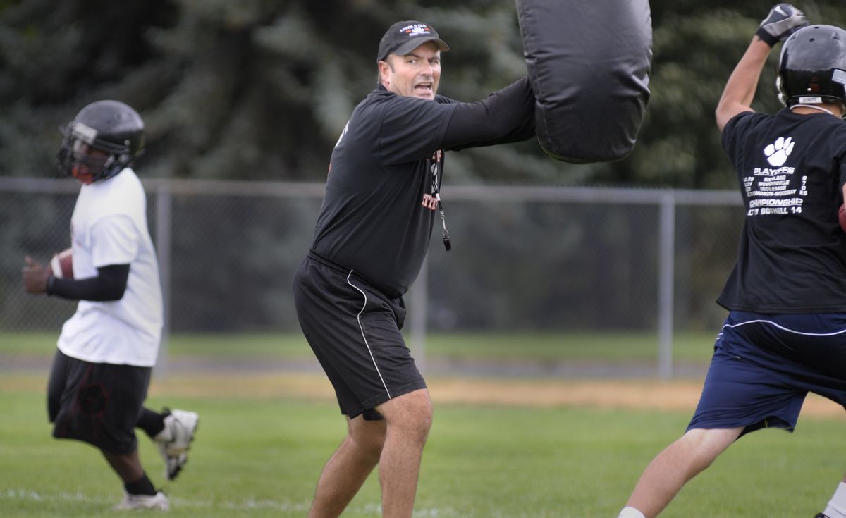 Lewis and Clark coach Tom Yearout, still amazed by last year’s title run, leads running backs through drills. (Christopher Anderson / The Spokesman-Review)