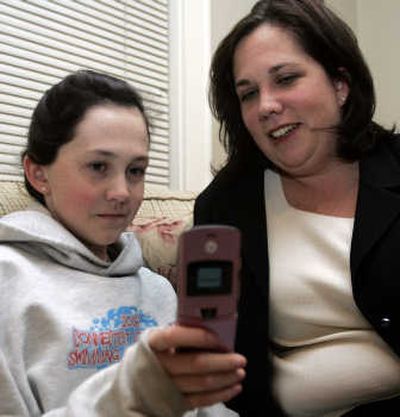 
Meghan Mulvany, 12, left, and her mother, Kate, look at Meghan's cell phone at their home in Stamford, Conn.  Meghan wanted a phone for personal reasons, but Kate bought it for her daughter's safety.Associated Press
 (Associated Press / The Spokesman-Review)