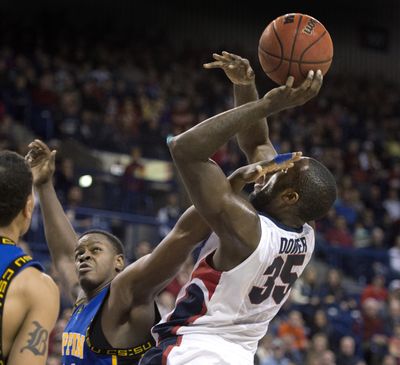 Gonzaga’s Sam Dower gets a facial from Coppin State’s Jerimyjah Batts in the first half of Sunday night’s game. Dower had 11 points. (Dan Pelle)
