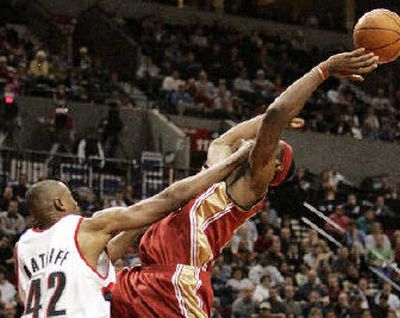 
Cleveland forward LeBron James, right, is fouled by Portland's Theo Ratliff.
 (Associated Press / The Spokesman-Review)