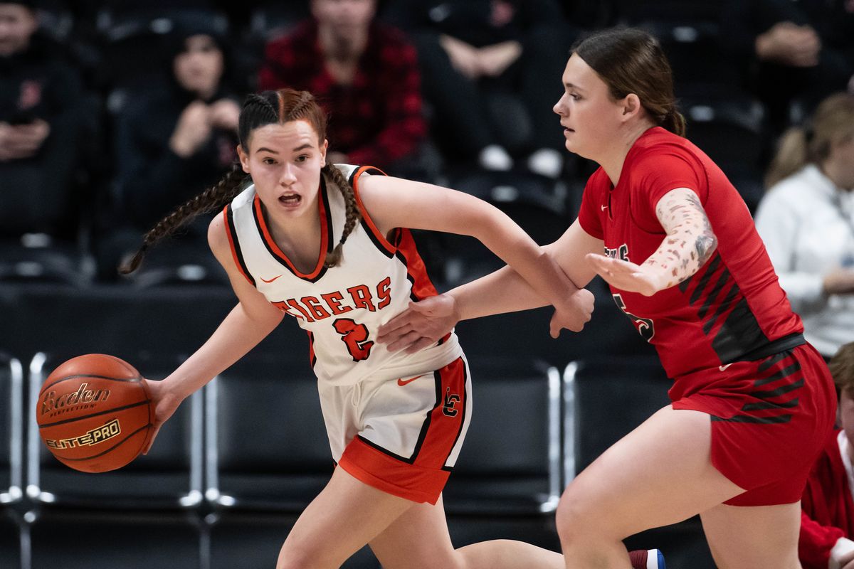 Lewis and Clark guard Olivia Baird (2) dribbles the ball as Ferris guard Abby Colton (5) defends during the Rubber Chicken high school basketball game, Thursday., Dec. 19, 2024, at the Spokane Veterans Arena.  (COLIN MULVANY)